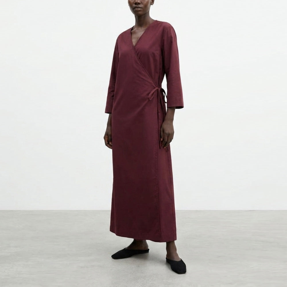 Discover the Sarita Caftan at The Luxe Maison, featuring an ankle-length wrap design, wide sleeves, adjustable side ties, and a V-neckline for effortless elegance.