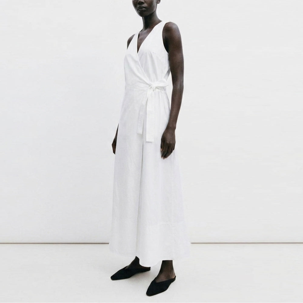 Discover the Sarita Dress at The Luxe Maison, featuring a versatile wrap design, adjustable side tie, and elegant draped back for effortless warm-weather style.
