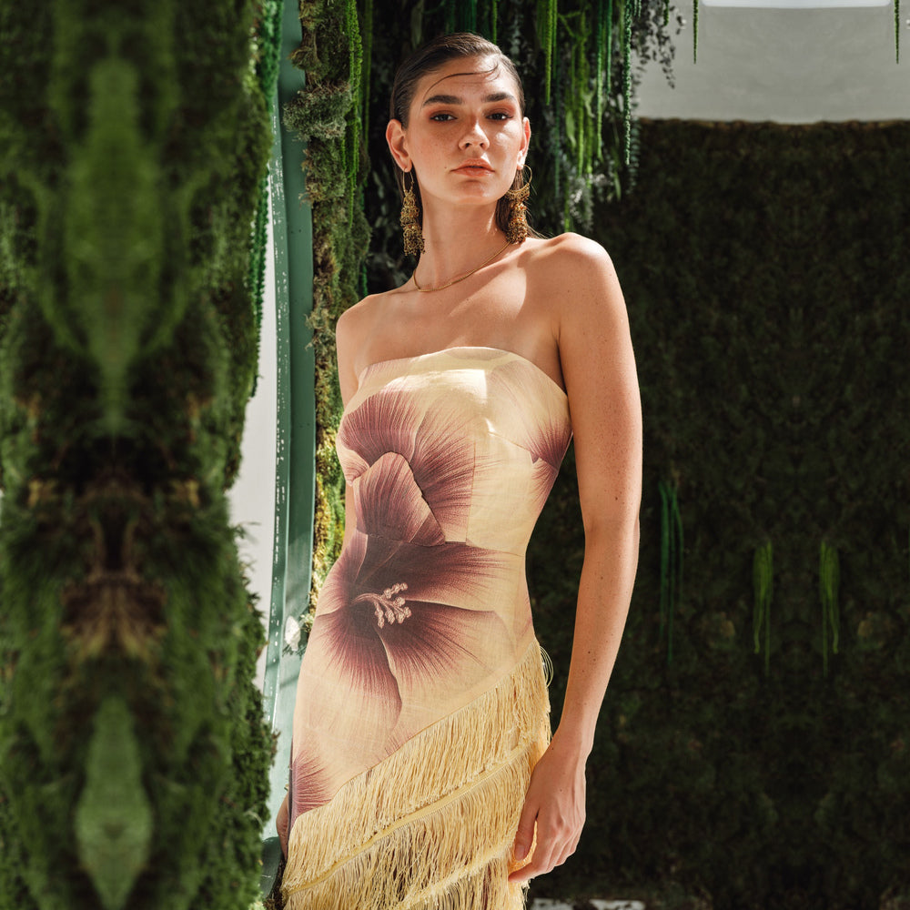 Shop online from our exclusive website and discover the Serena Dress by Nana Gotti, a strapless linen midi dress with a bold floral print, structured bodice, and cascading fringe details.