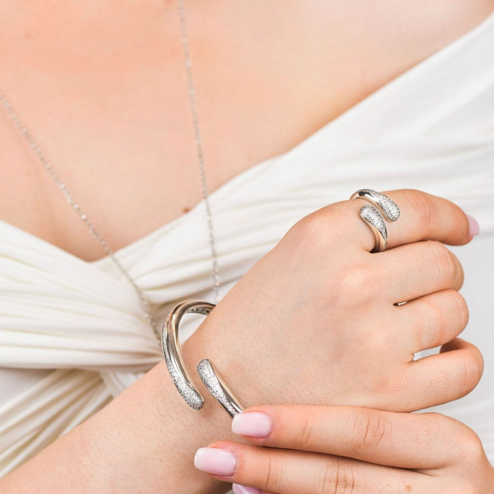 Elegant rhodium-plated bronze wrap cuff bracelet with sparkling pavé cubic zirconia stones for a modern luxe look. Shop premium jewelry online.