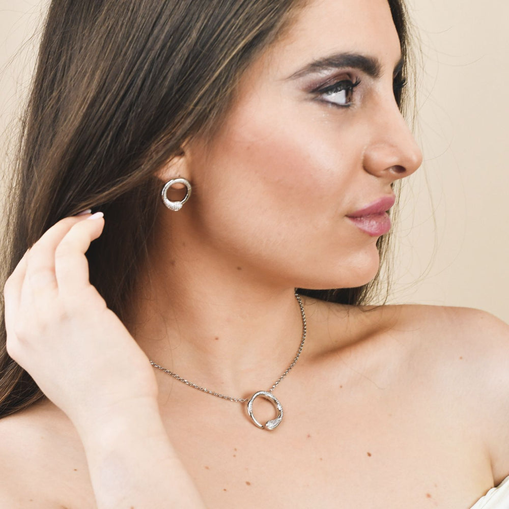Shop online premium rhodium plated silver pendant necklace with sparkling pave cubic zirconia circle design.