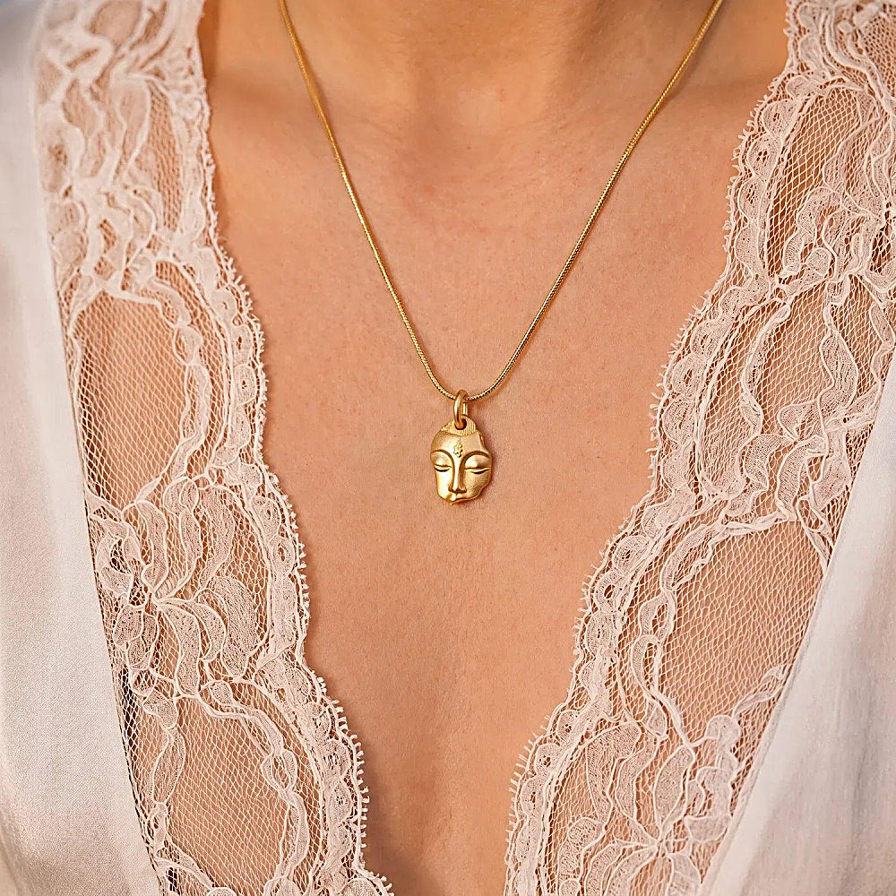 Discover the Silent Wisdom Guanyin Pendant Necklace at The Luxe Maison, featuring an elegant 18K gold-plated Guanyin design symbolizing compassion, serenity, and wisdom.