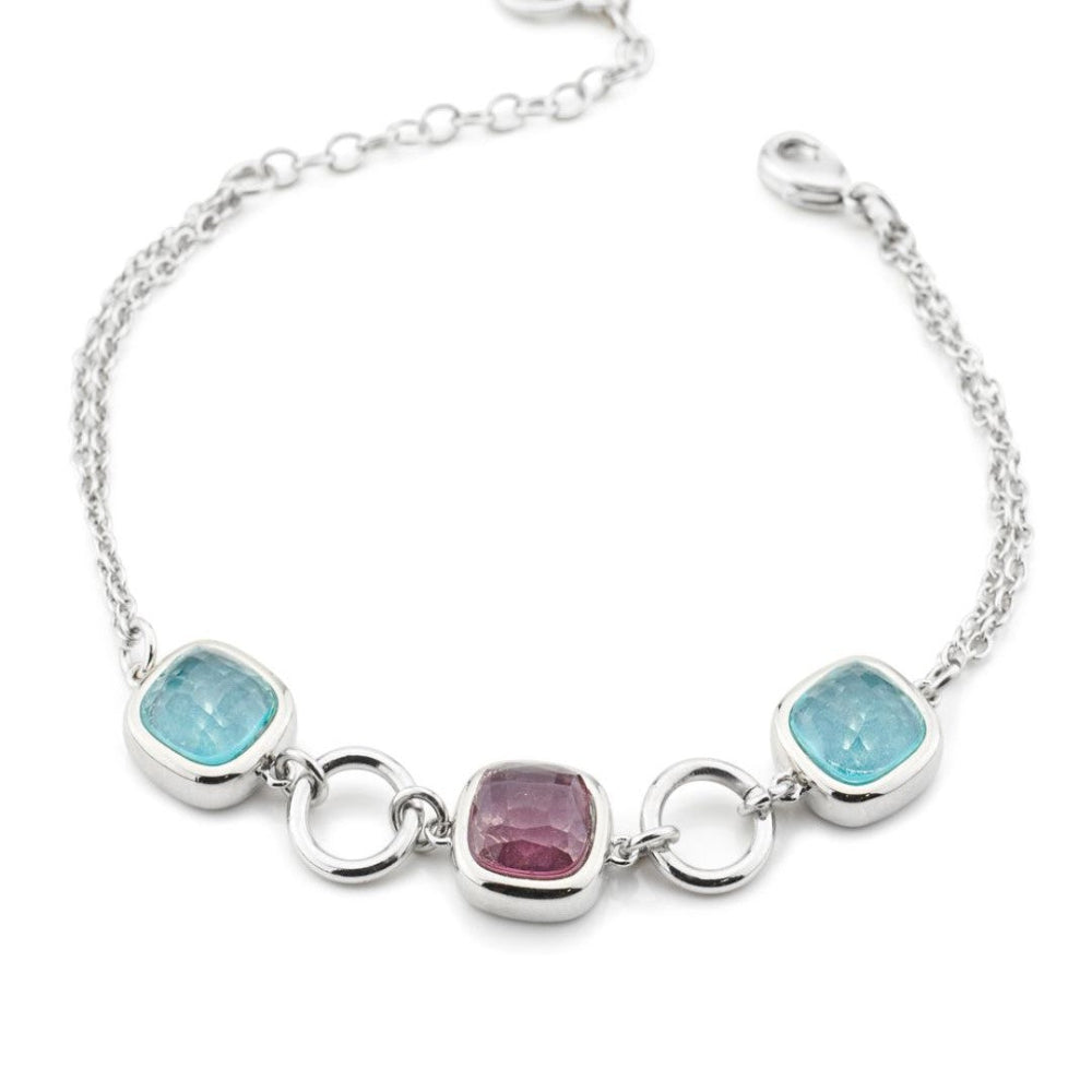 Rhodium-plated bracelet with purple amethyst and milky blue crystal accents, paired with sleek circular modules for a contemporary statement look. Shop premium jewelry online.
