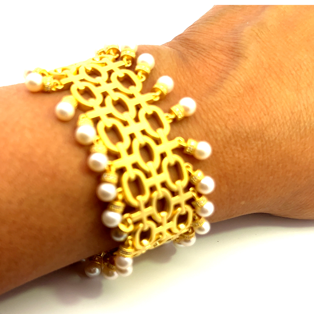 Sterling silver 18k gold-dipped bracelet with freshwater pearls and sparkling cubic zirconia accents for a refined timeless look. Shop premium jewelry online.