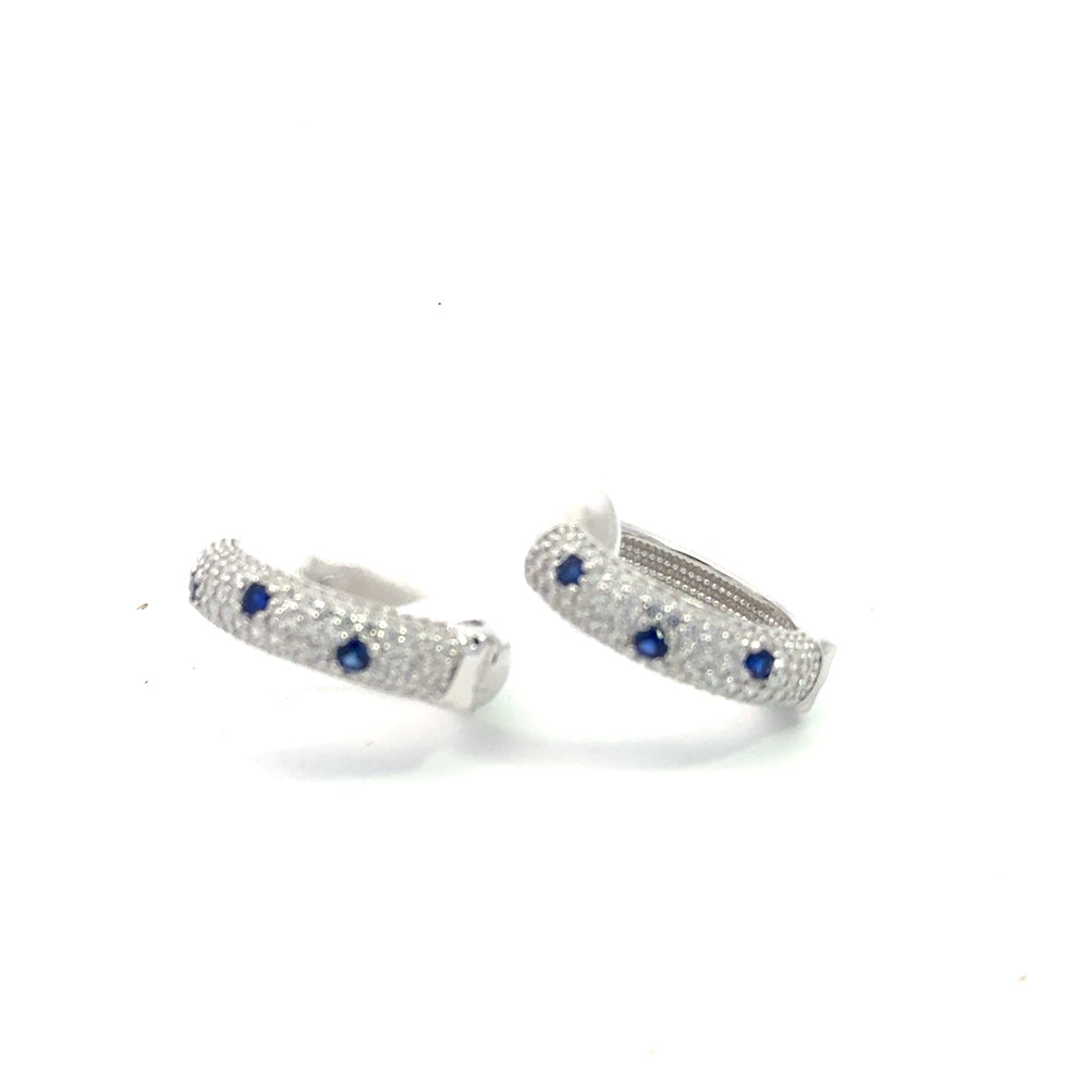 Shop sterling silver blue sapphire huggie earrings featuring lab-created blue sapphire, sparkling cubic zirconia, and an elegant oval pavé design.