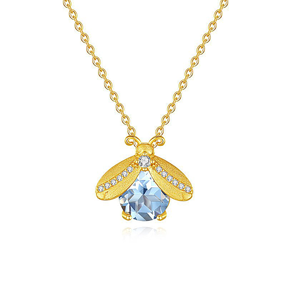 Discover the Summer Firefly Blue Topaz Gold Vermeil Necklace at The Luxe Maison, featuring a faceted blue topaz gemstone, sterling silver wings, and sparkling zircon accents for a delicate, luminous touch.