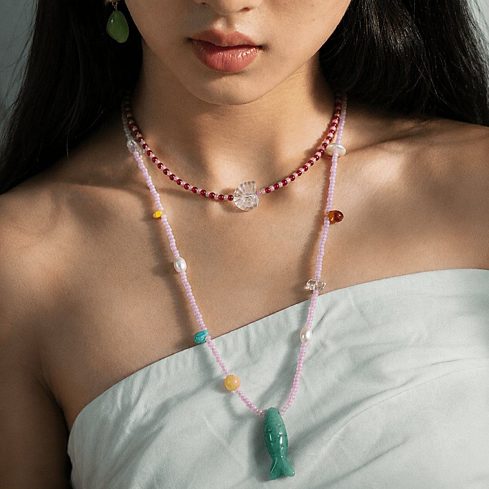 Discover the Summertime Aventurine Fish Necklace at The Luxe Maison, featuring green aventurine, freshwater pearls, white crystal, and pastel beads for a playful, colorful summer look.