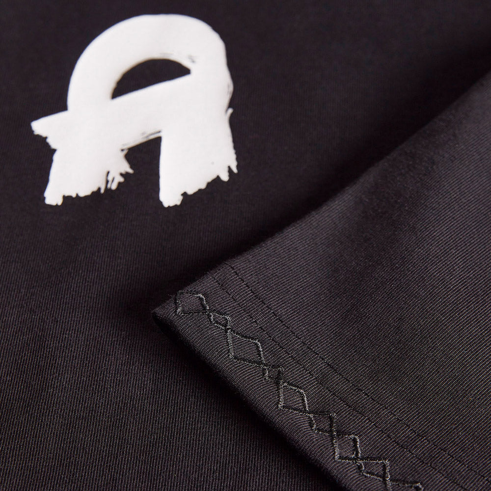 The Oversized Signature Tee Black at clothing store for women. Shop Now!