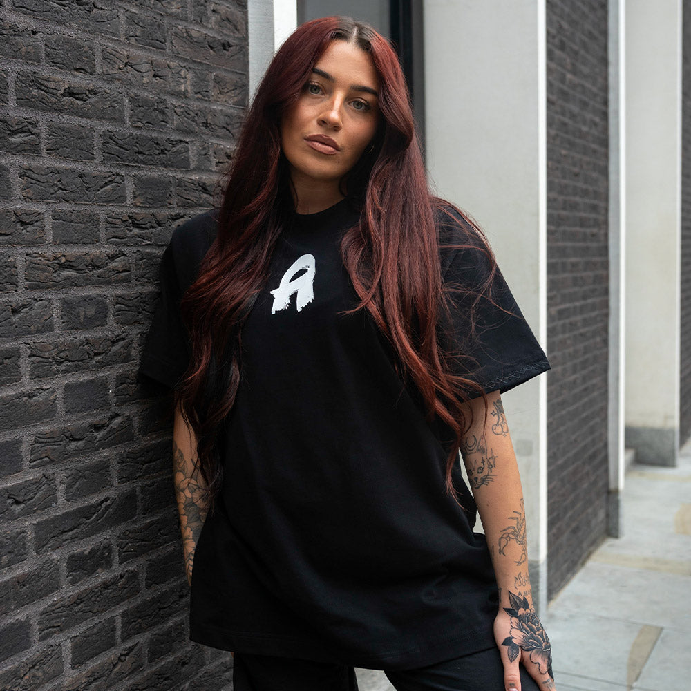 The Oversized Signature Tee Black at clothing store for women. Shop Now!