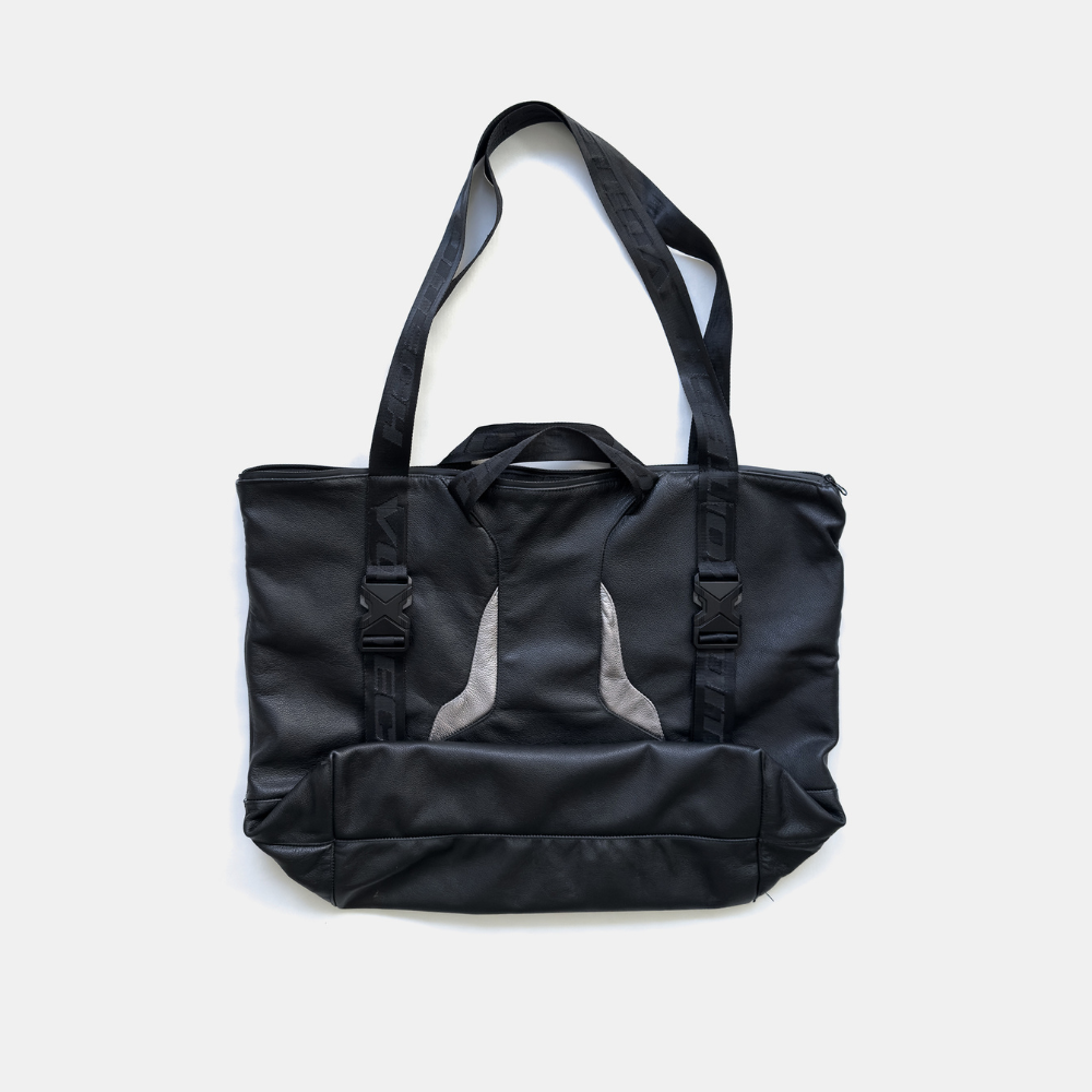 Shop online from our exclusive website and discover the Torque Leather Tote by Voitech®, featuring premium leather, reinforced webbing, technical detailing, and a sculptural motorsport-inspired design.
