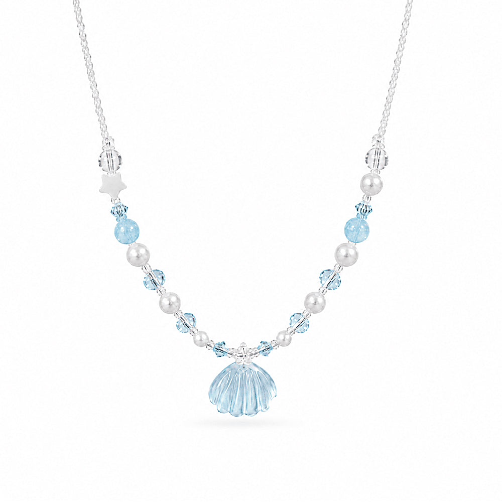 Discover the Venus Aquamarine Shell Beaded Necklace at The Luxe Maison, featuring a carved aquamarine shell pendant, luminous pearls, sparkling crystal beads, and a delicate star for an elegant ocean-inspired look.