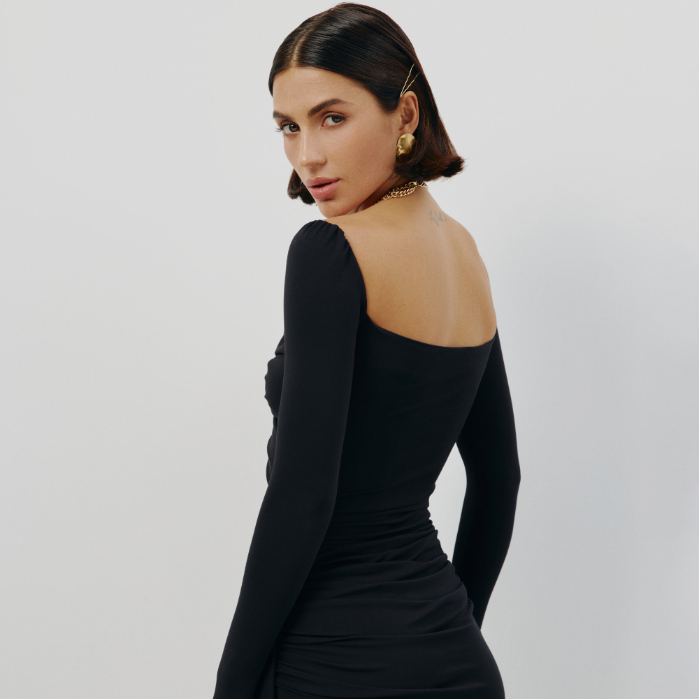 Perfectly fitted knit dress with a gold chain detail and elegant leg-length train. Shop now at our exclusive clothing website.