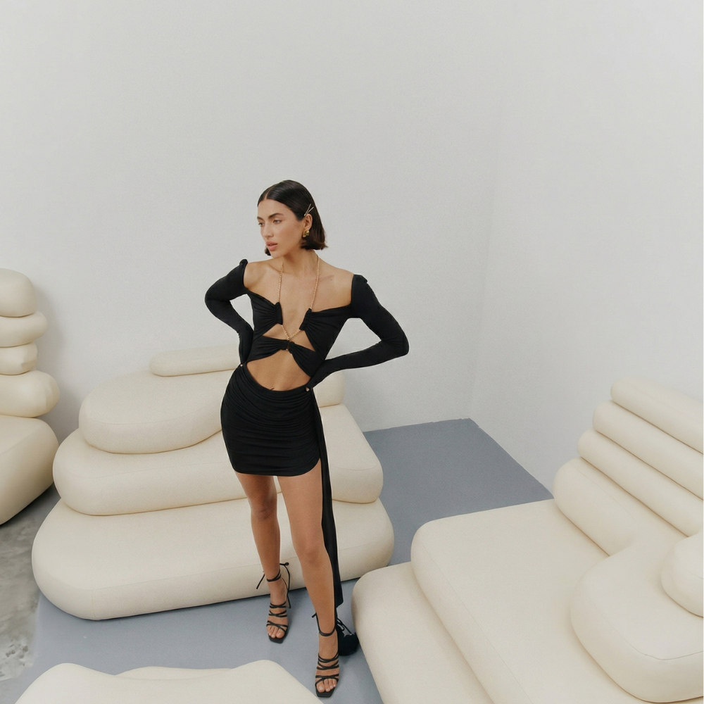 Perfectly fitted knit dress with a gold chain detail and elegant leg-length train. Shop now at our exclusive clothing website.