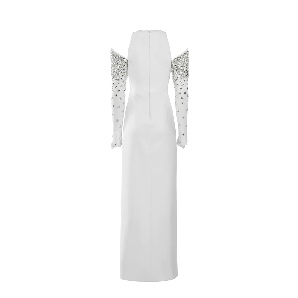 A white silk crepe dress with a center front slit and crystal embroidered structured sleeves.