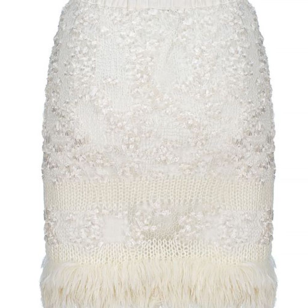 White Sundown Handmade Knit Skirt with pearl buttons on the front looks like a piece of art. 