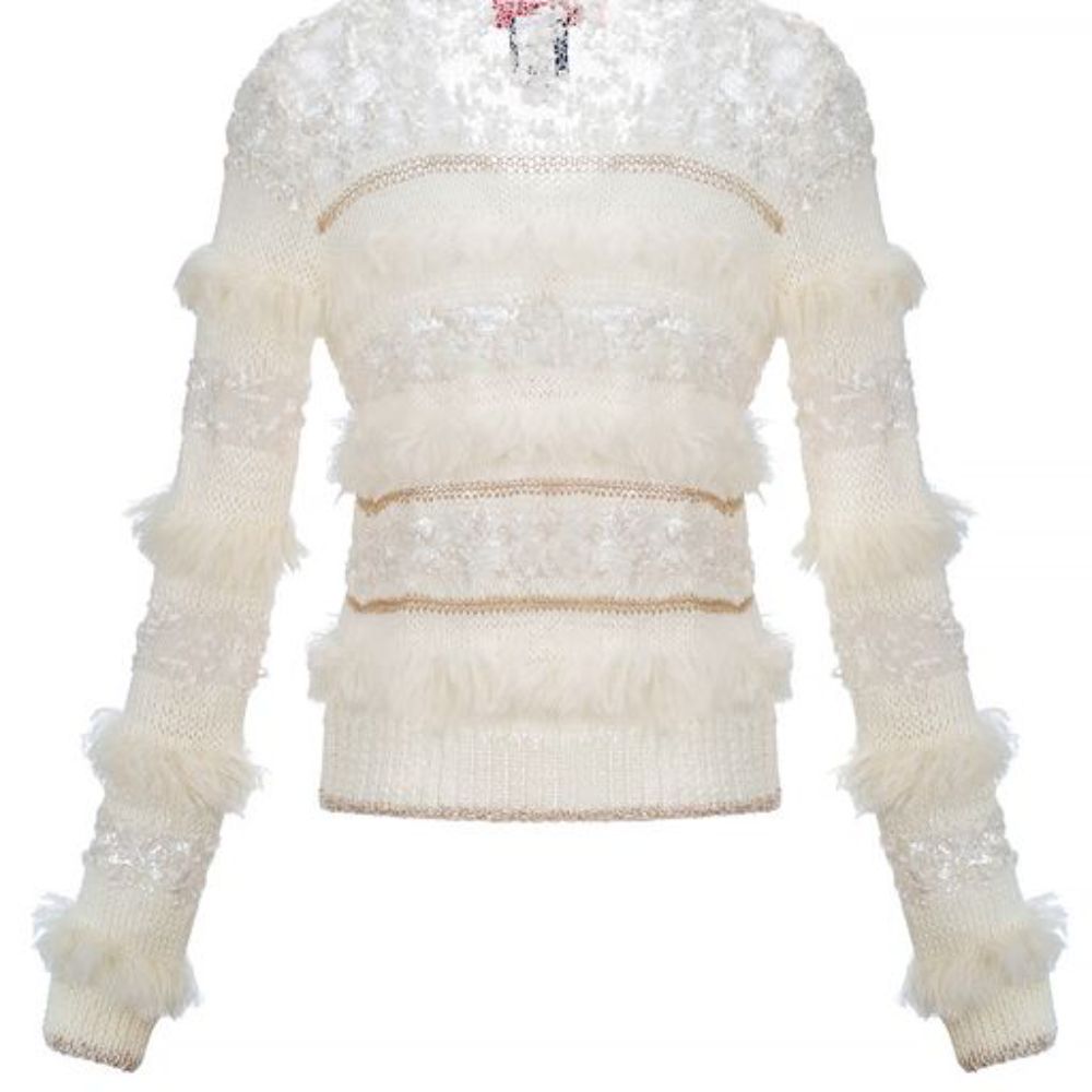 White Sundown Handmade Knit Sweater with long sleeves has wavy knit ruffles and looks like a piece of art. 