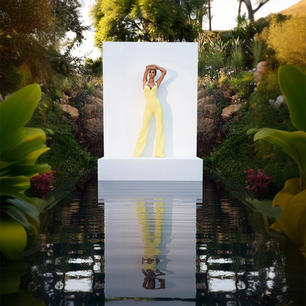 A canary yellow crepe corseted jumpsuit with crystal embroidered straps.