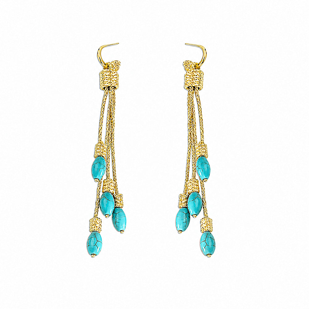 Discover the Dakini Turquoise Tassel Earrings at The Luxe Maison, featuring cascading strands of vibrant turquoise inspired by the celestial sky dancers of the Himalayas. With their graceful movement and mystical charm, these statement earrings add a touch of bohemian elegance to everyday outfits and special occasions.