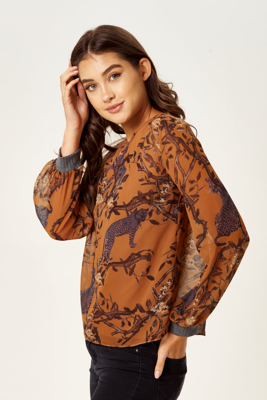 Enjoy online shopping with the stylish Women's Cheetah Print Long Sleeve Top in Grey. Shop Now!