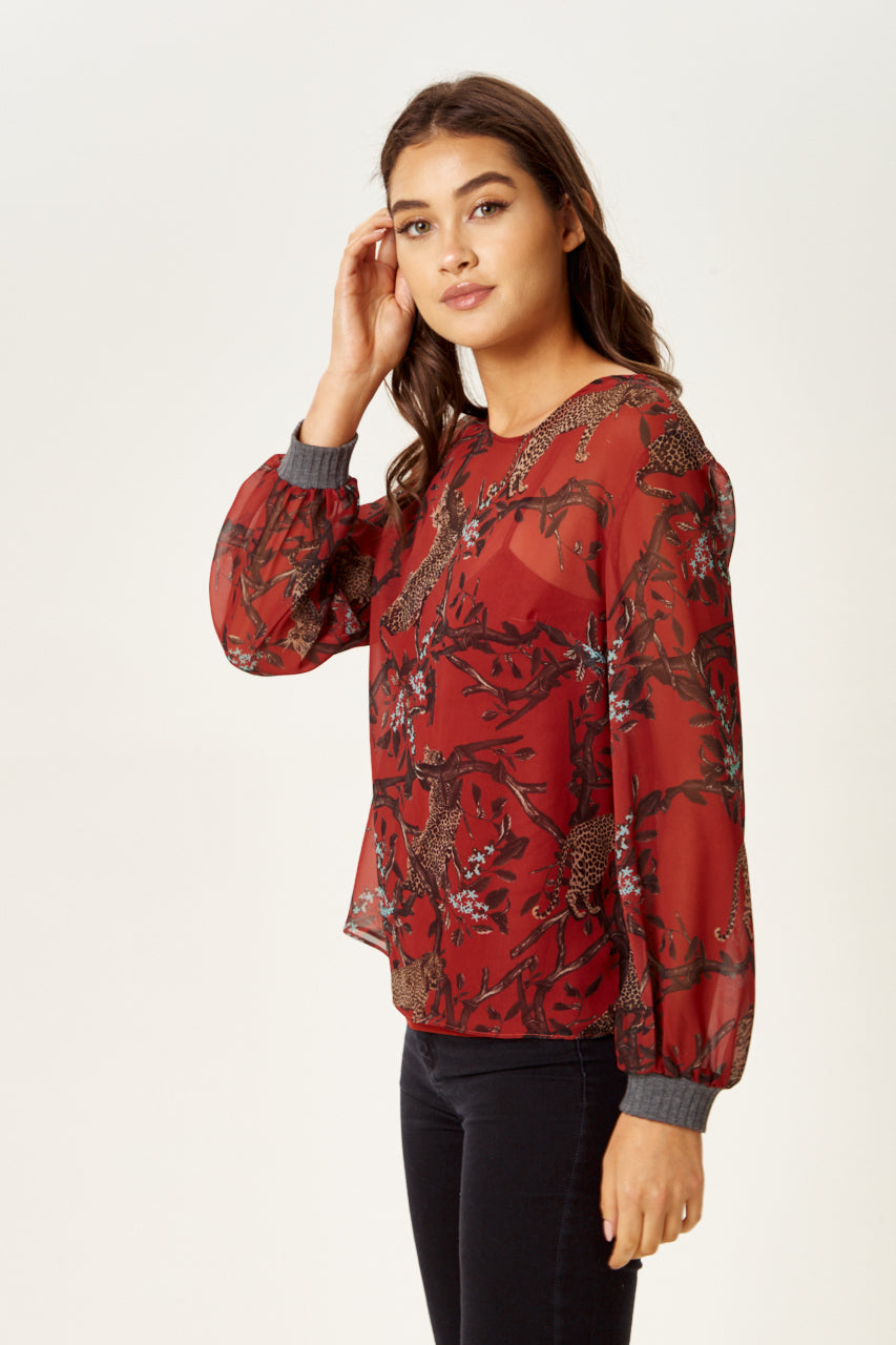 Find trendy luxury dresses online including the Women's Long Sleeve Red Leopard Top. Shop Now!