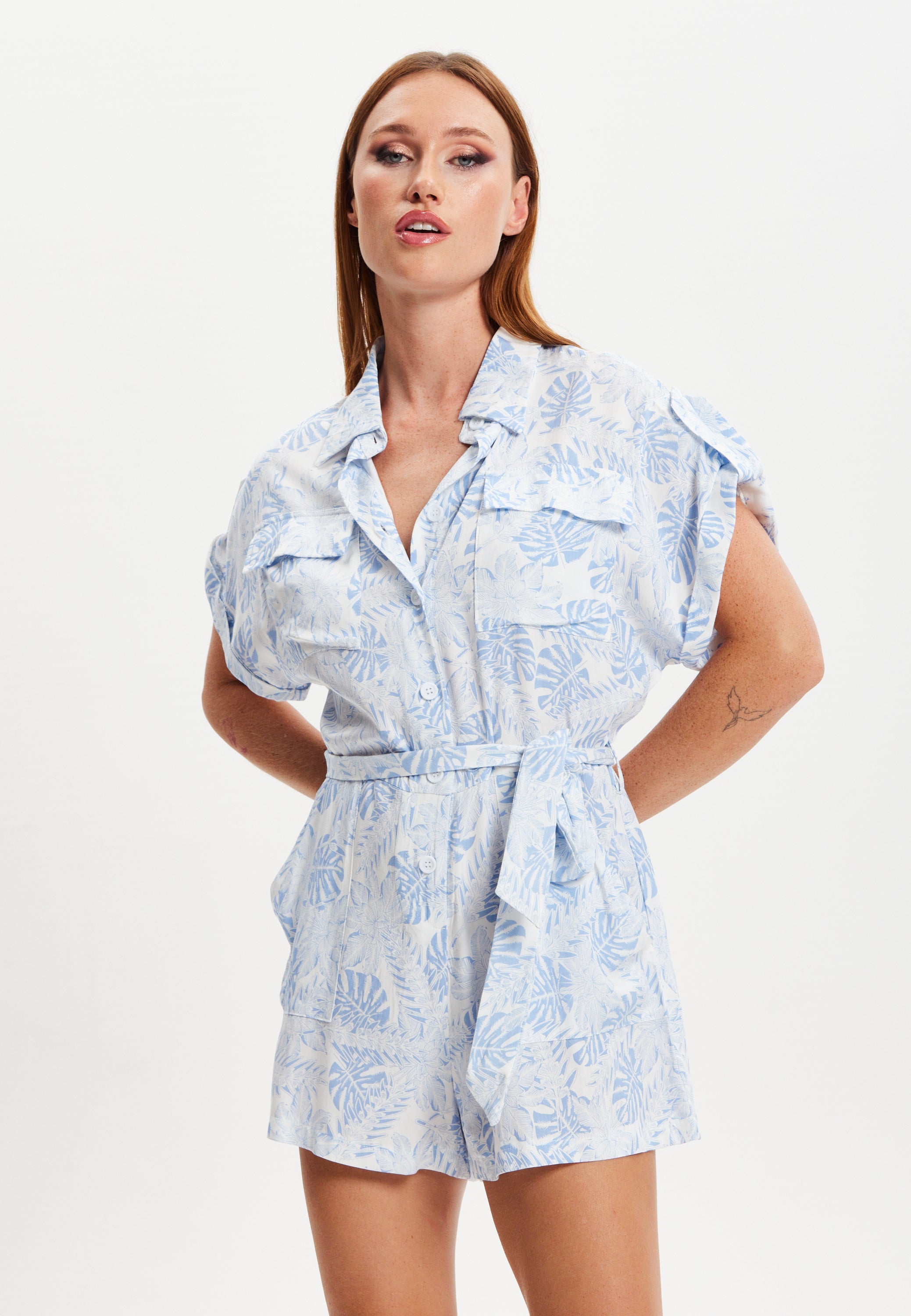 Women's Blue Leaf Printed Playsuit with Button Down, Short Sleeve, Front & Side Pockets, Loose Fit, Casual Style.