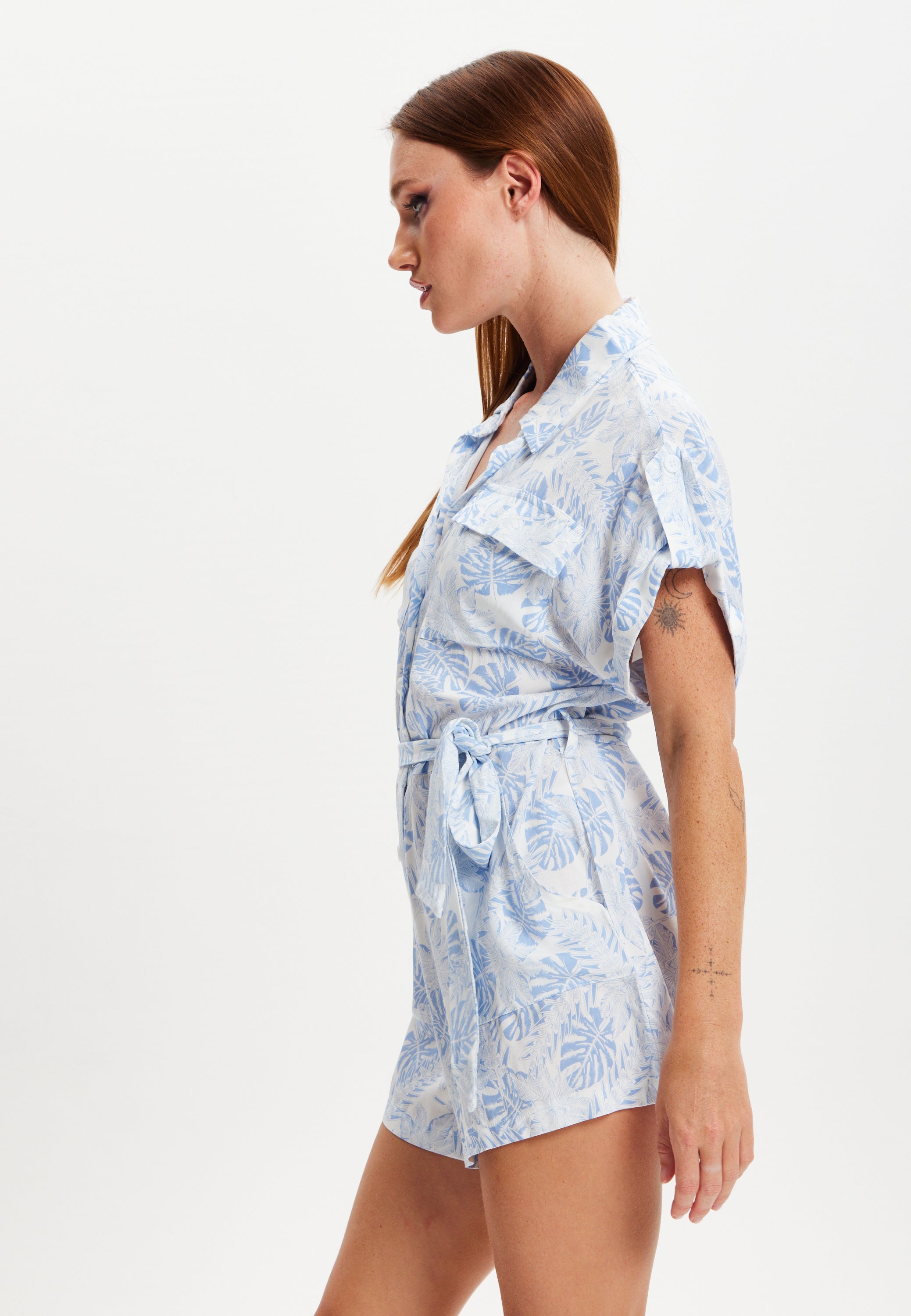 Women's Blue Leaf Printed Playsuit with Button Down, Short Sleeve, Front & Side Pockets, Loose Fit, Casual Style.