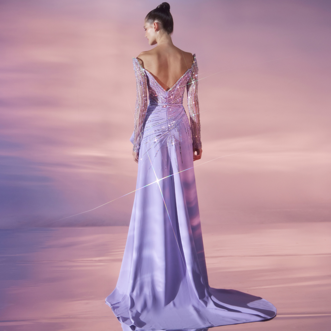 Long Lavender Cady dress with a side slit featuring stones and sequence embellished long-sleeve sweetheart bodice.