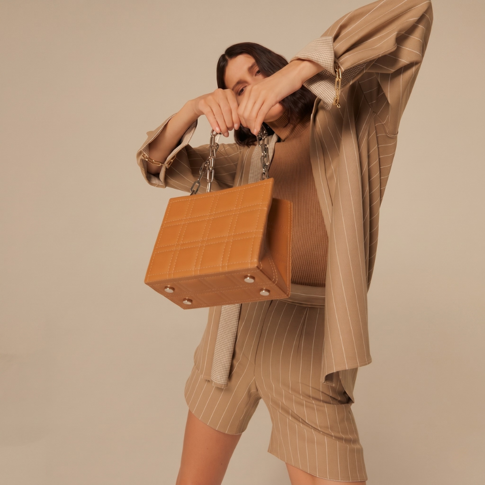 Leather bag with adjustable strap and flap closure, perfect for daily use. Shop online from our curated edit of premium fashion.