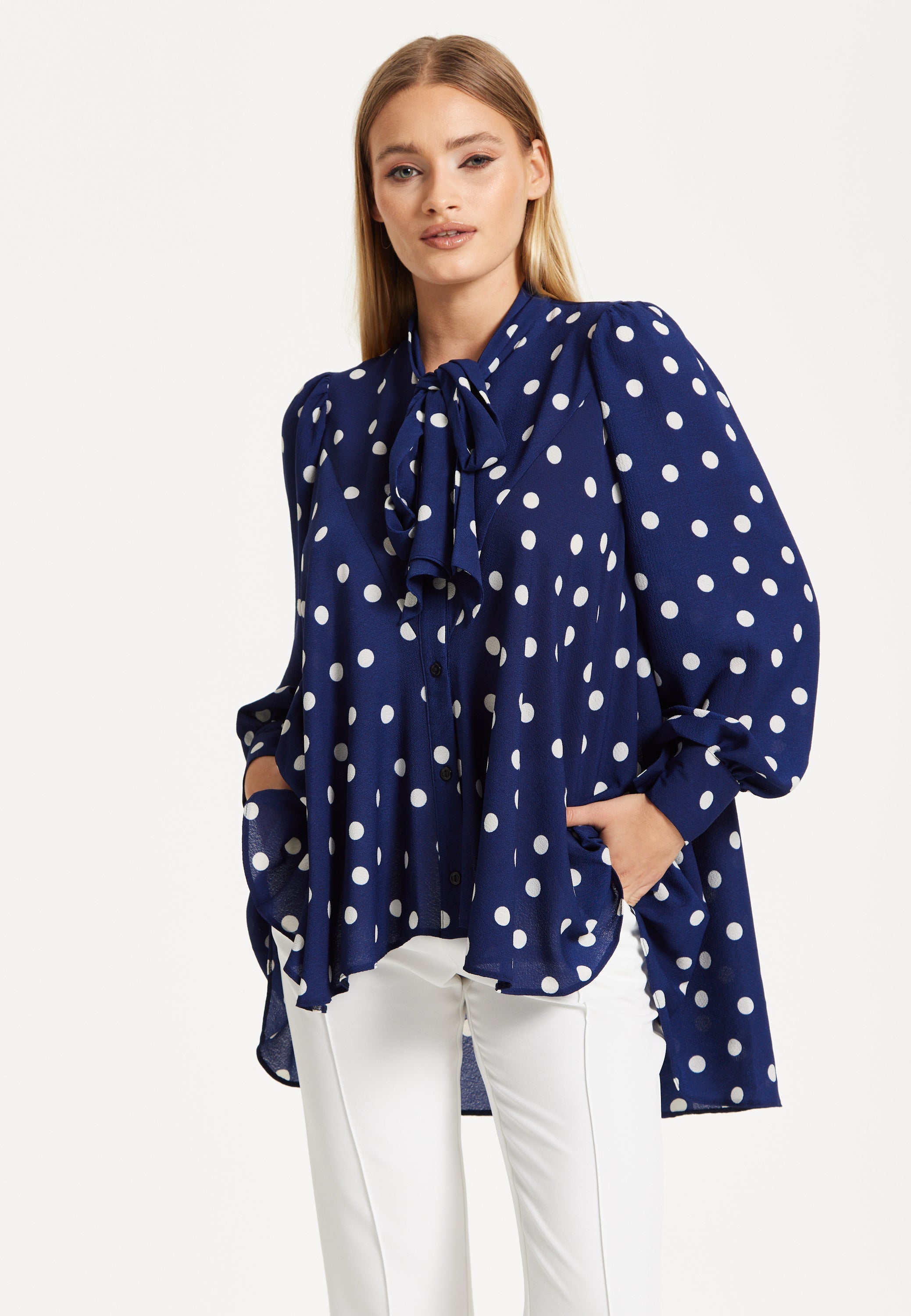 Navy Polka Dot Flared Hem Blouse