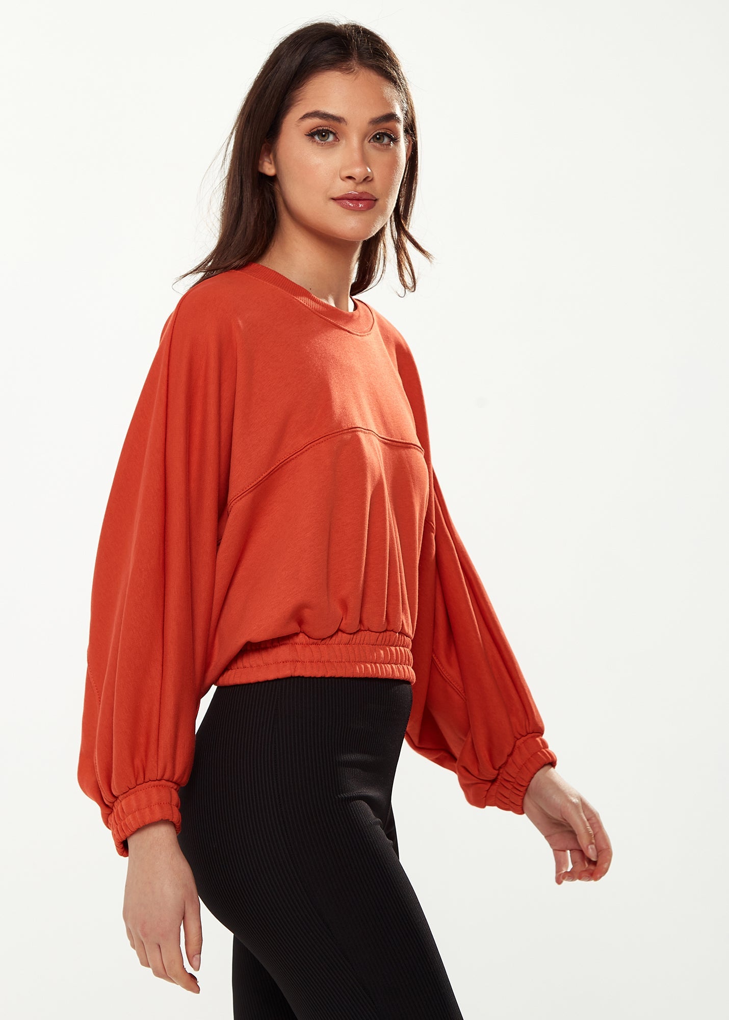 Women's Cropped Sweatshirt in Dark Orange with Voluminous Bat and Balloon Sleeves, Elastic Cuffs, and a Chic Design.