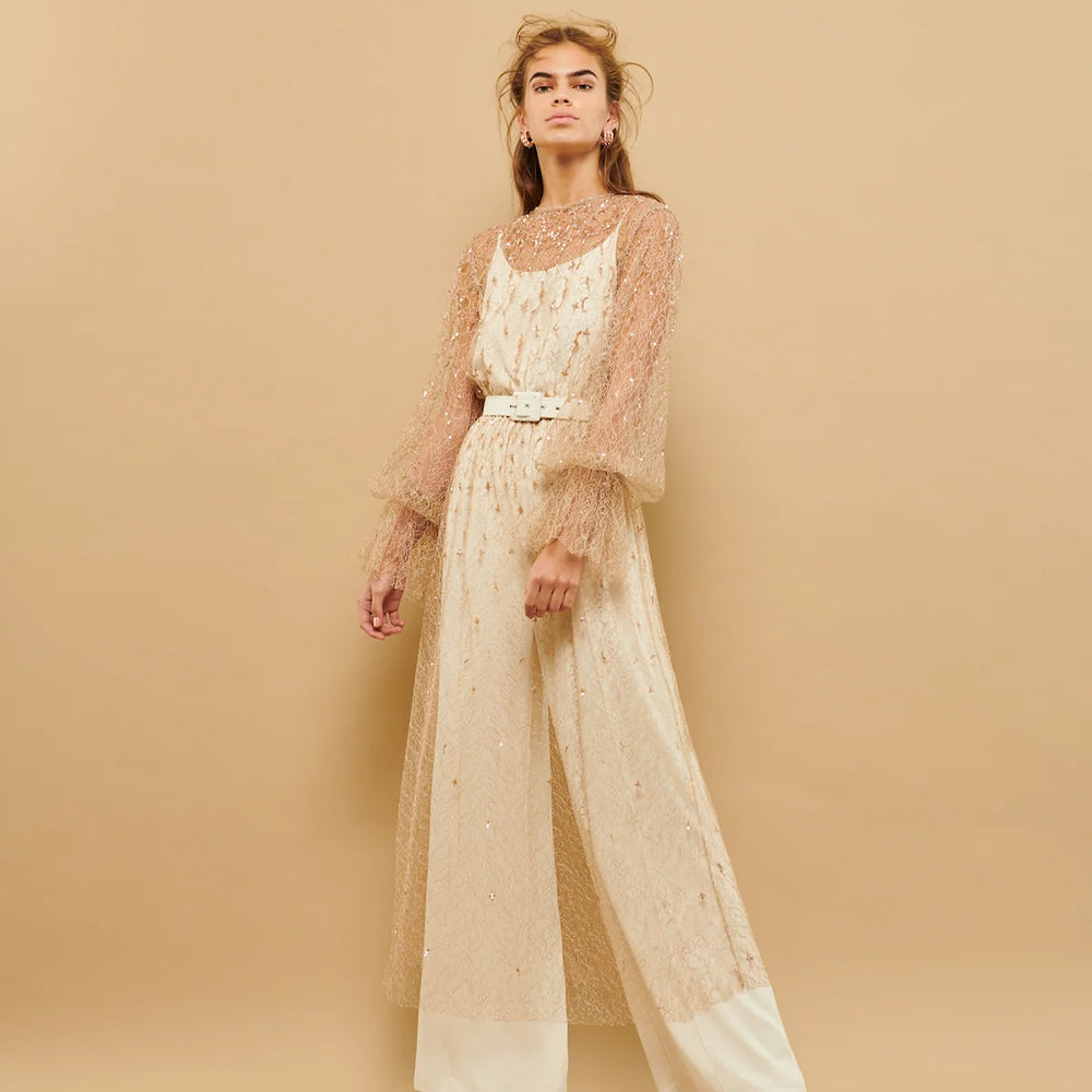 This pantsuit combines sheer tulle and embroidery, offering a chic and sophisticated look.