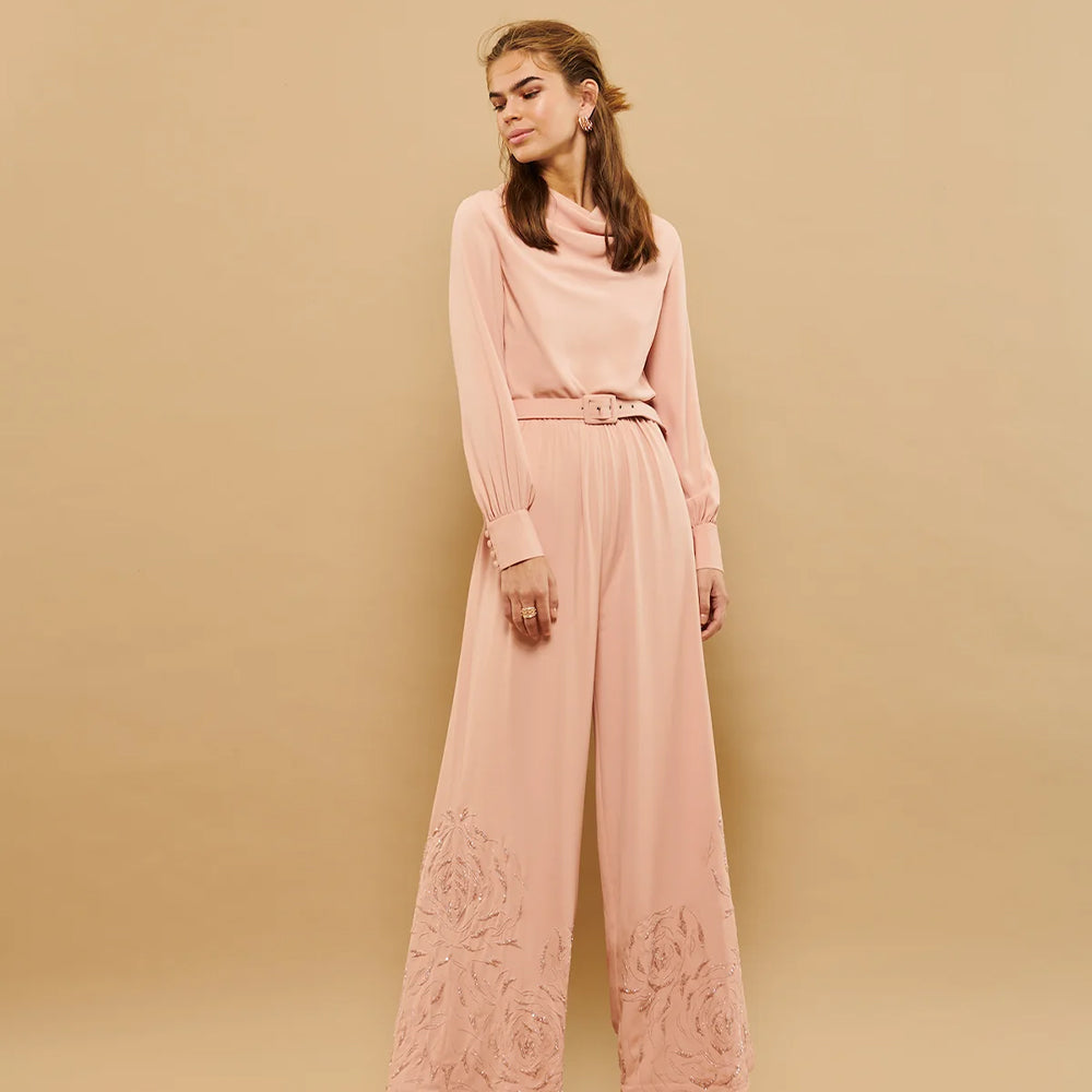 Cowl neck pantsuit with embroidered hemline and belt - a chic blend of style and sophistication.