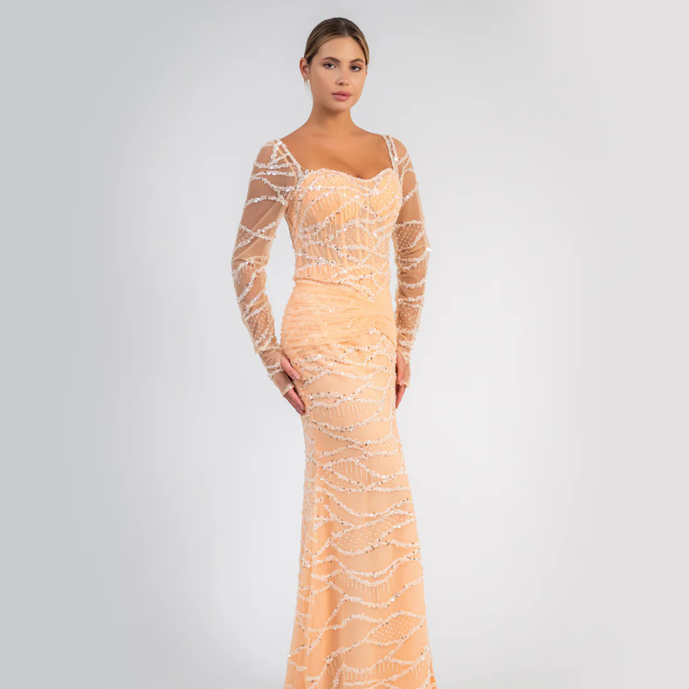 Shop online striking peach gown with shimmering details, sheer sleeves and graceful flowing silhouette, perfect for parties and special occasions.