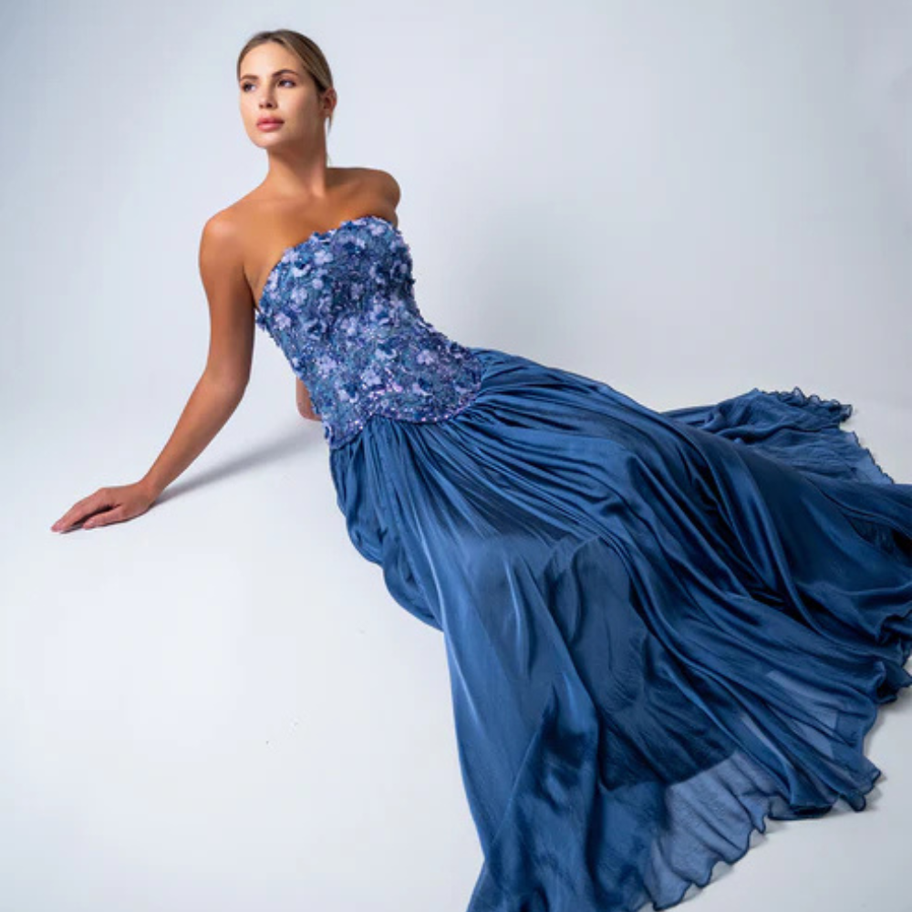 Shop online smoky blue gown with sculpted corset, floral embellishments and graceful flowing pleats, perfect for parties and special occasions.