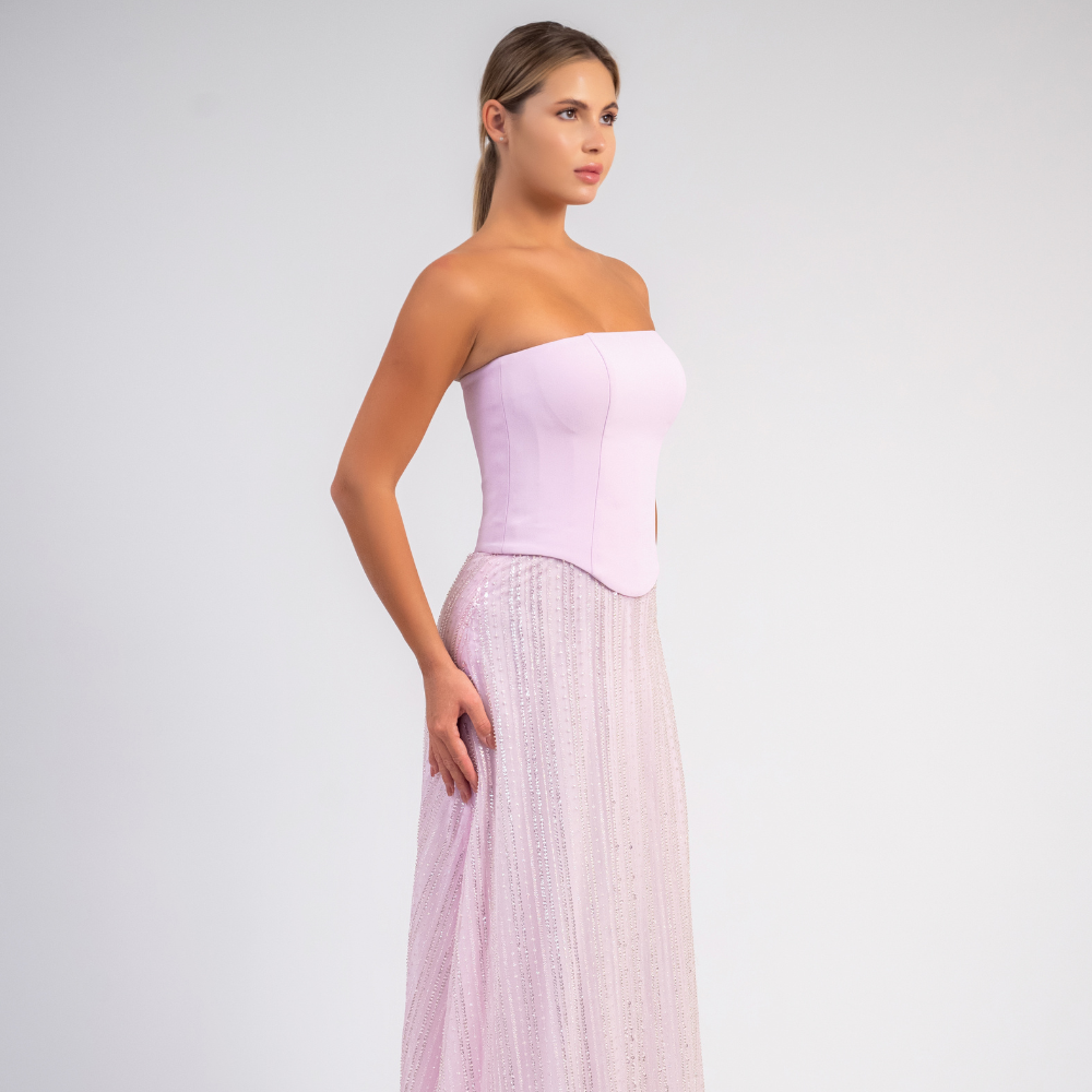 Shop online strapless pastel pink evening gown with structured corset and flowing embellished tulle skirt, perfect for parties and special occasions.
