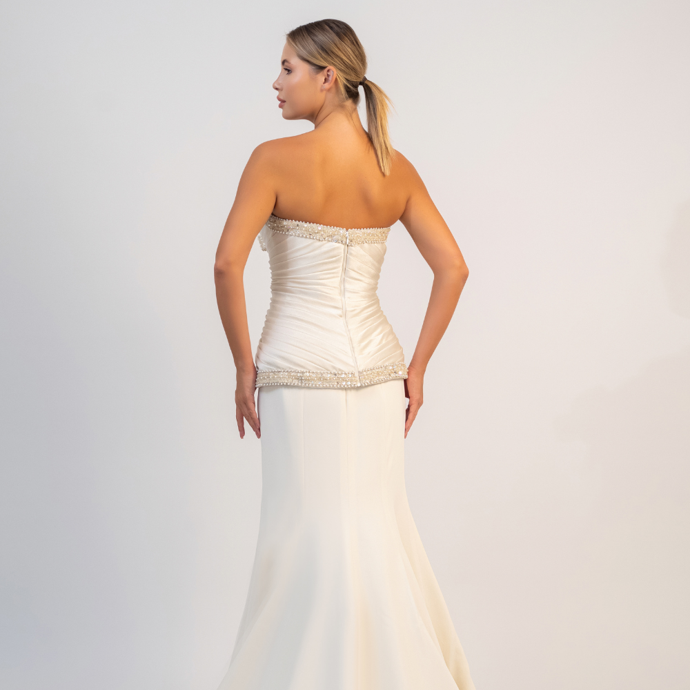 Shop online elegant off-white gown with sculpted bodice, sparkling details and graceful mermaid silhouette, perfect for weddings, parties and special occasions.
