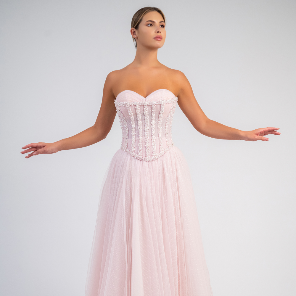 Shop online soft light pink strapless gown with corset bodice, delicate embellishments and flowing layered skirt, perfect for parties and special occasions.