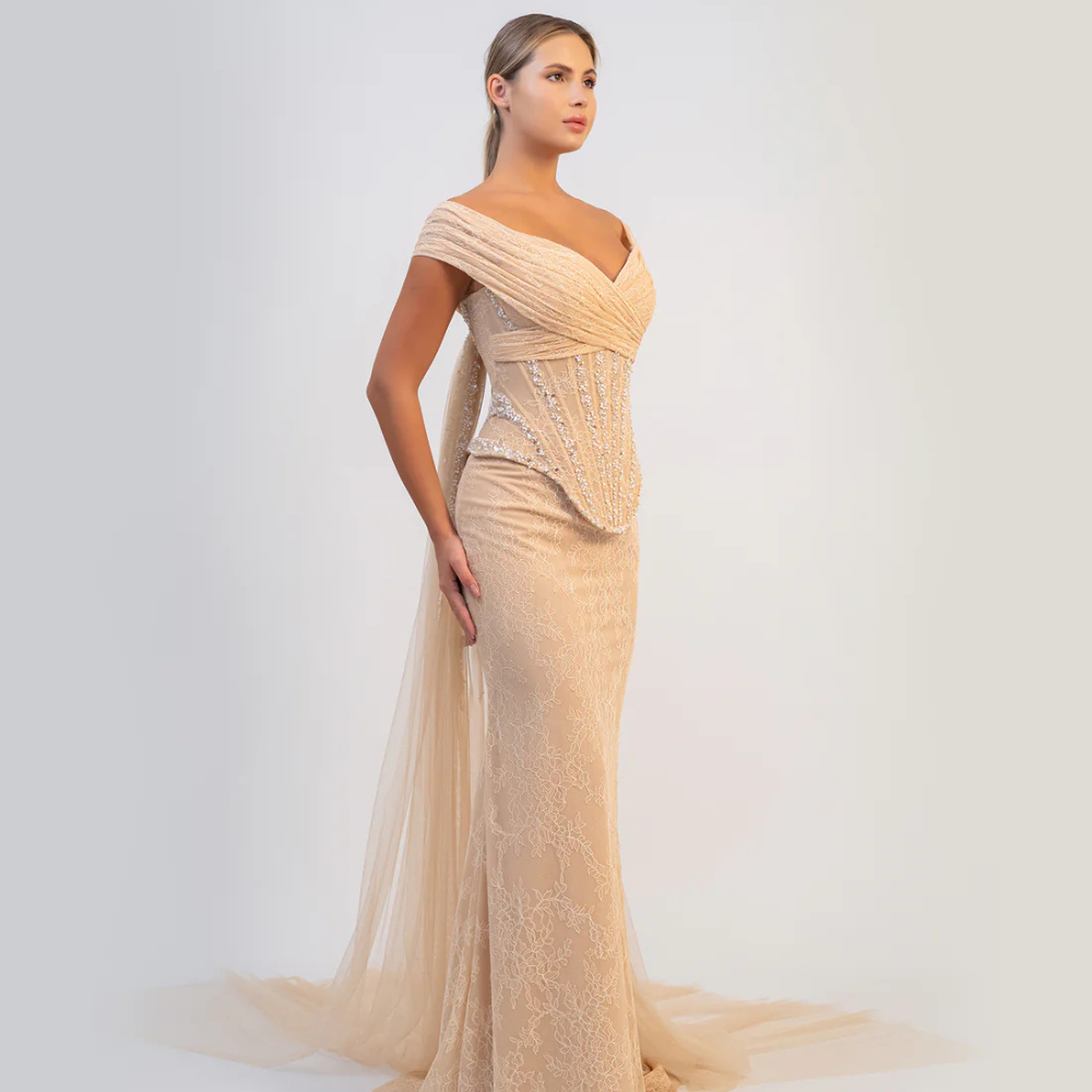Shop online exquisite champagne mermaid gown with sculpted corset, delicate embellishments and timeless elegance, perfect for parties and special occasions.