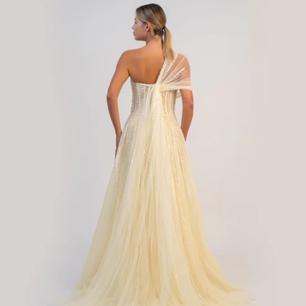 Shop online butter yellow A-line gown with sculpted corset, delicate shimmer and soft draped tulle details, perfect for parties and special occasions.
