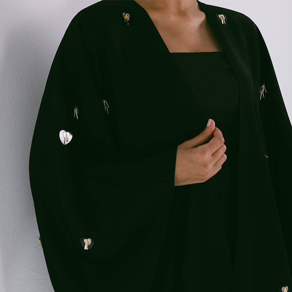 Classic abaya with scattered embroidery in crepe fabric. Comes with sheila. Explore our range of designer abayas online at The Luxe Maison. Shop now!