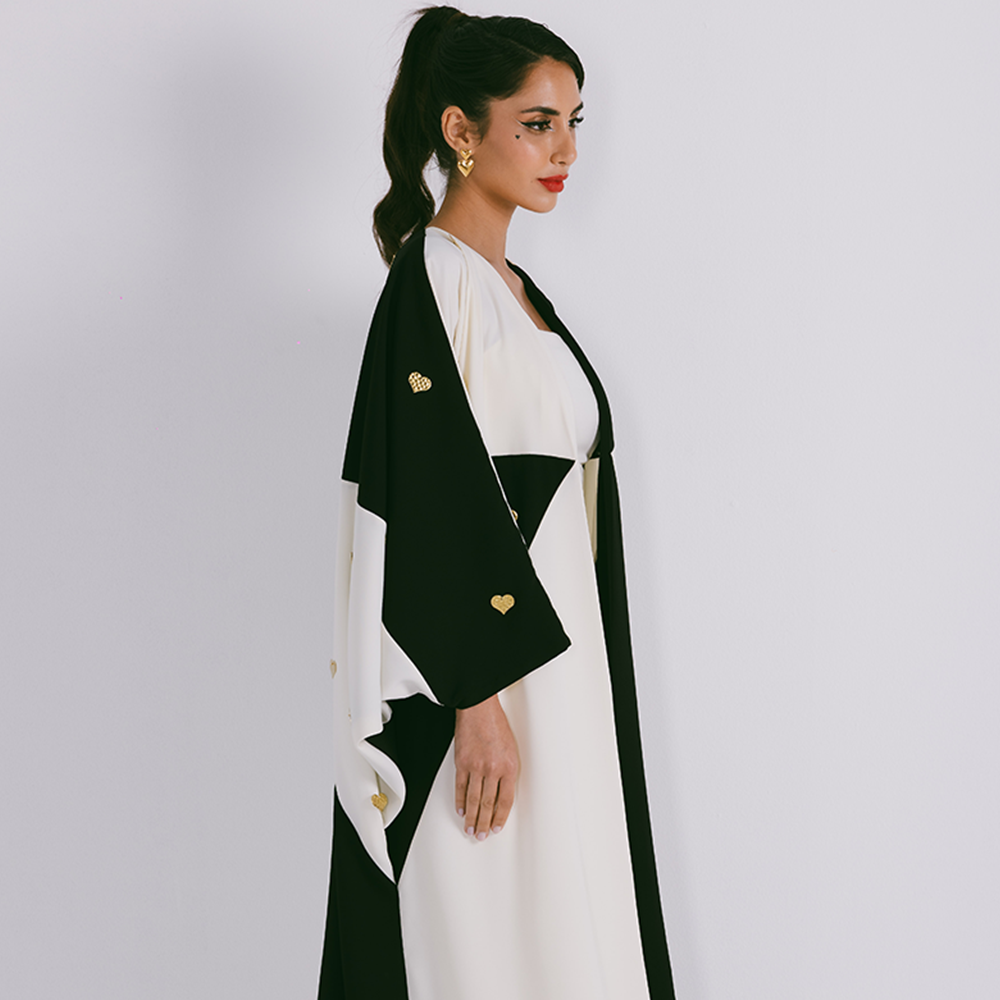 Two tone abaya in crepe with scattered metal heart motifs. Comes in one size only. Comes with sheila. Shop exclusive women clothing. Shop now!