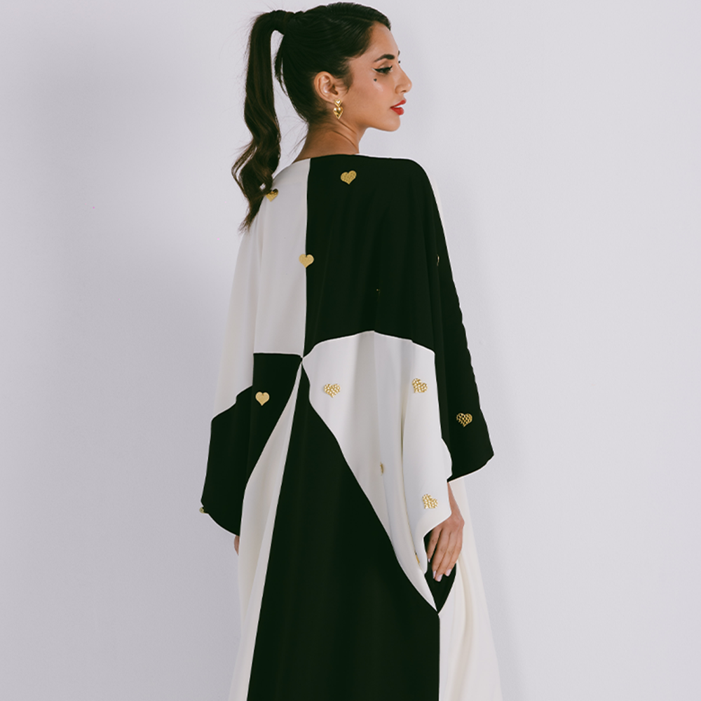 Two tone abaya in crepe with scattered metal heart motifs. Comes in one size only. Comes with sheila. Shop exclusive women clothing. Shop now!