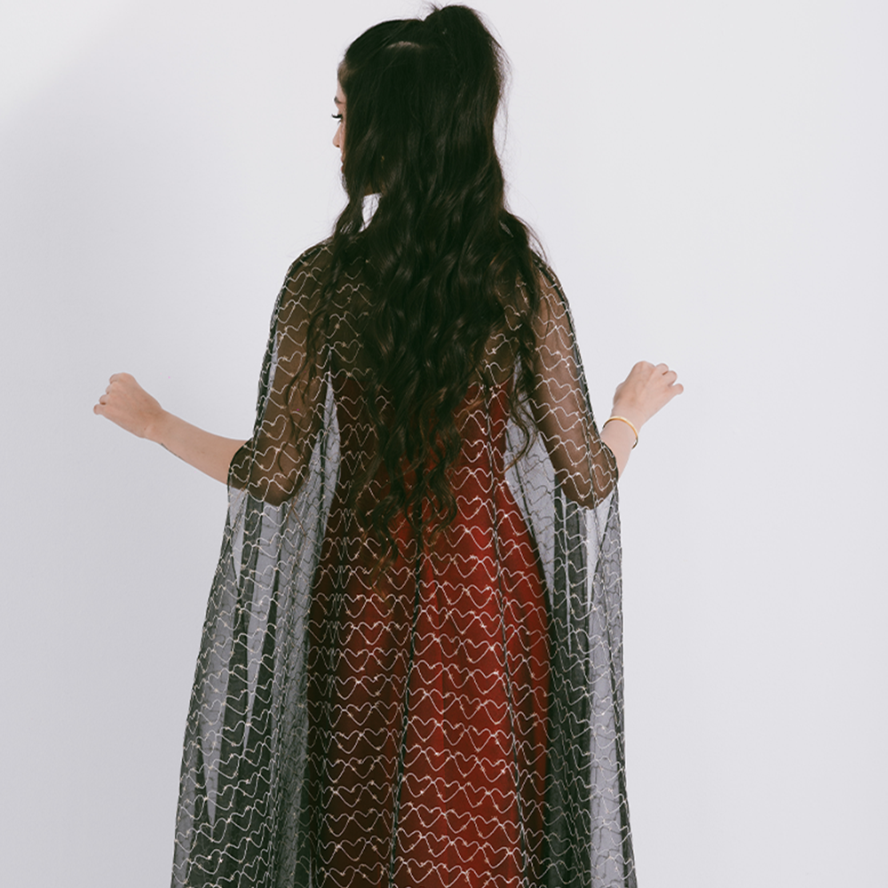 Organza cape with neck bow & heart shaped metallic threads on transparent fabric. Dress sold separately. Explore stylish capes for women. Shop now!