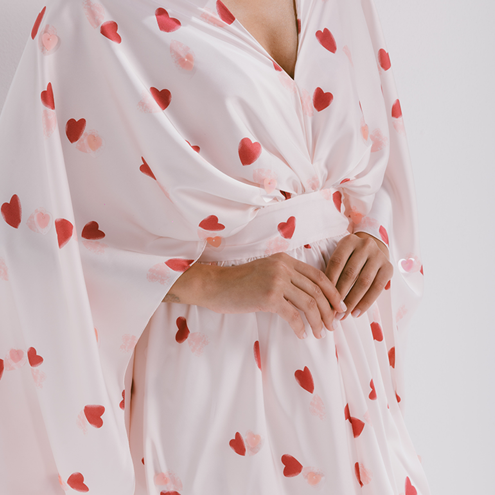 Drapped silk kaftan with belt in heart shaped prints. Dry clean only. Explore silk kaftans for women available on The Luxe Maison. Shop now!