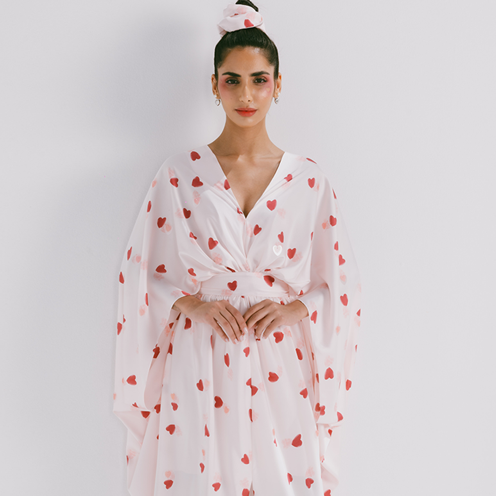 Drapped silk kaftan with belt in heart shaped prints. Dry clean only. Explore silk kaftans for women available on The Luxe Maison. Shop now!