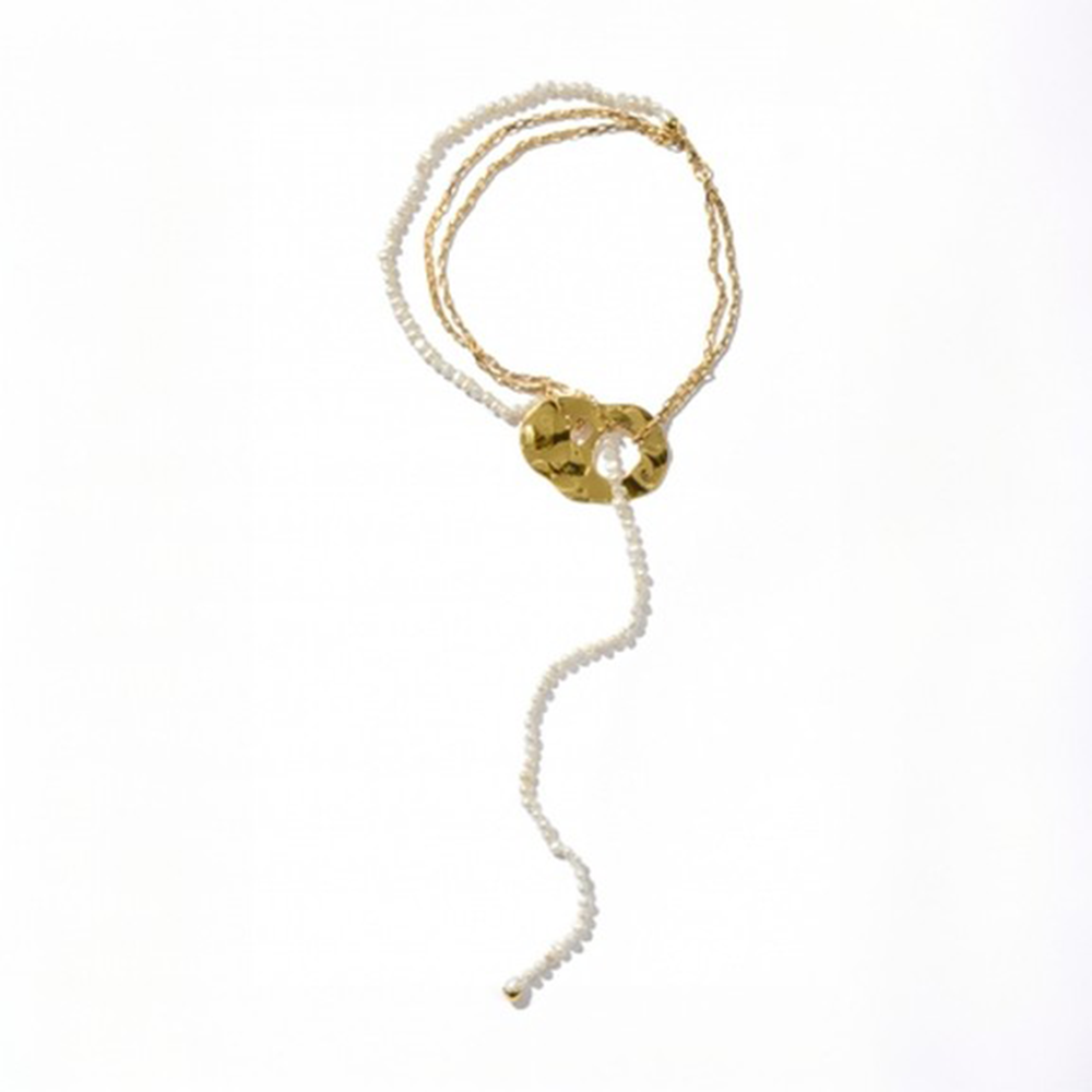 Long pearl and chain necklace with oversized reflective surface detail.