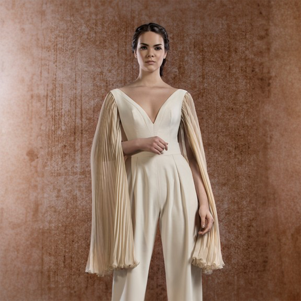 Beige overall with pleated silk mousseline sleeves. Perfect party wear women suit.