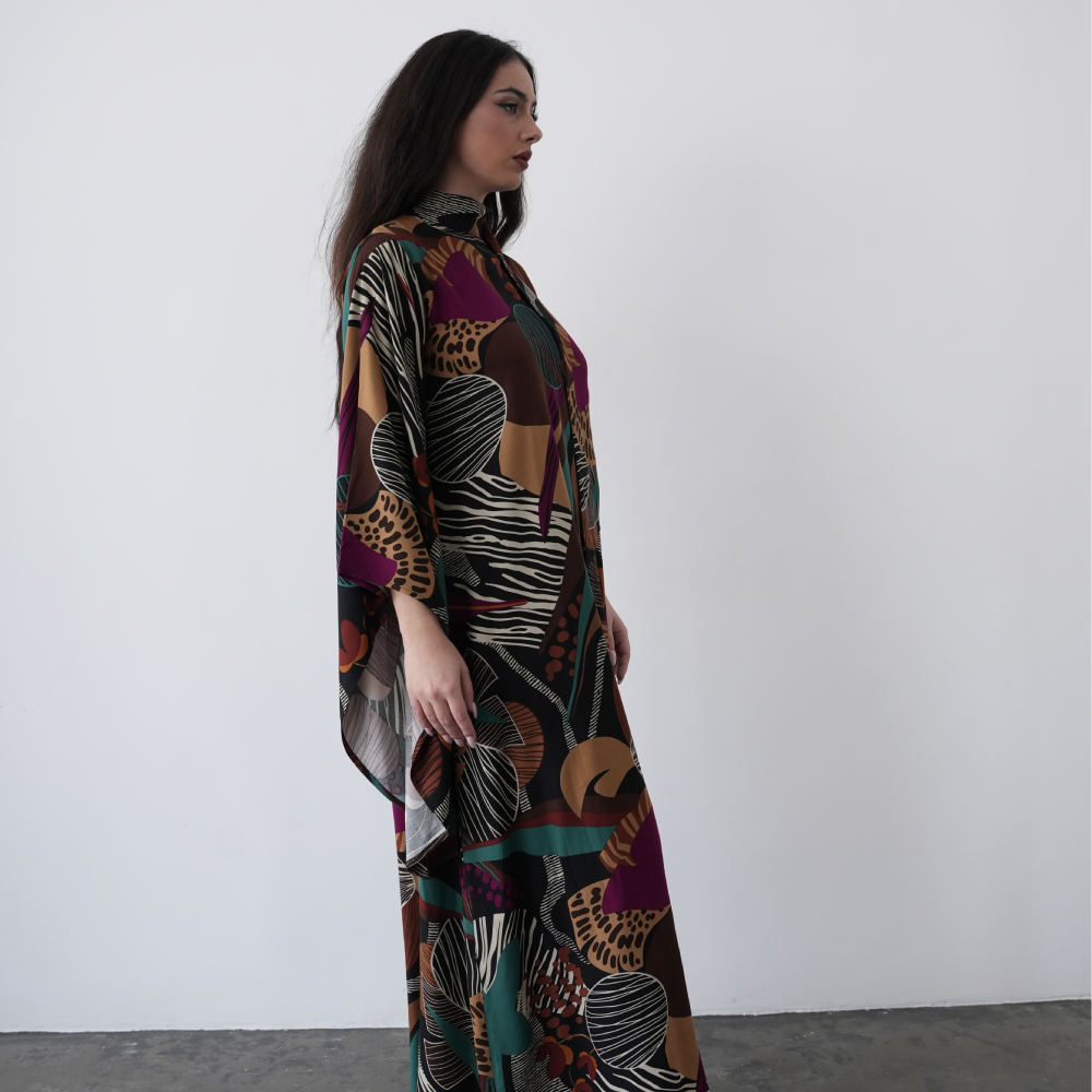 A-line maxi dress with long flared sleeves and a halterneck with attached scarf, with a deep V back cut.