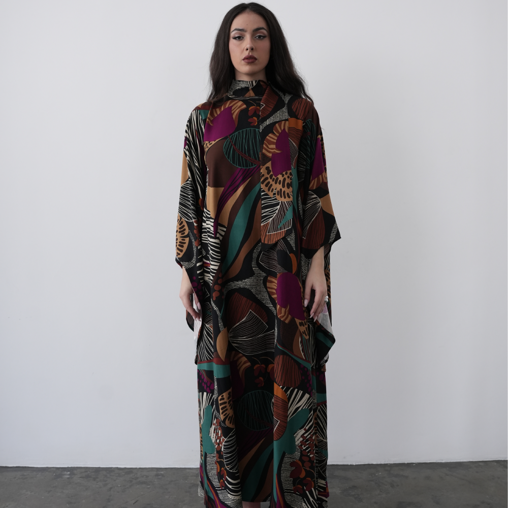 A-line maxi dress with long flared sleeves and a halterneck with attached scarf, with a deep V back cut.