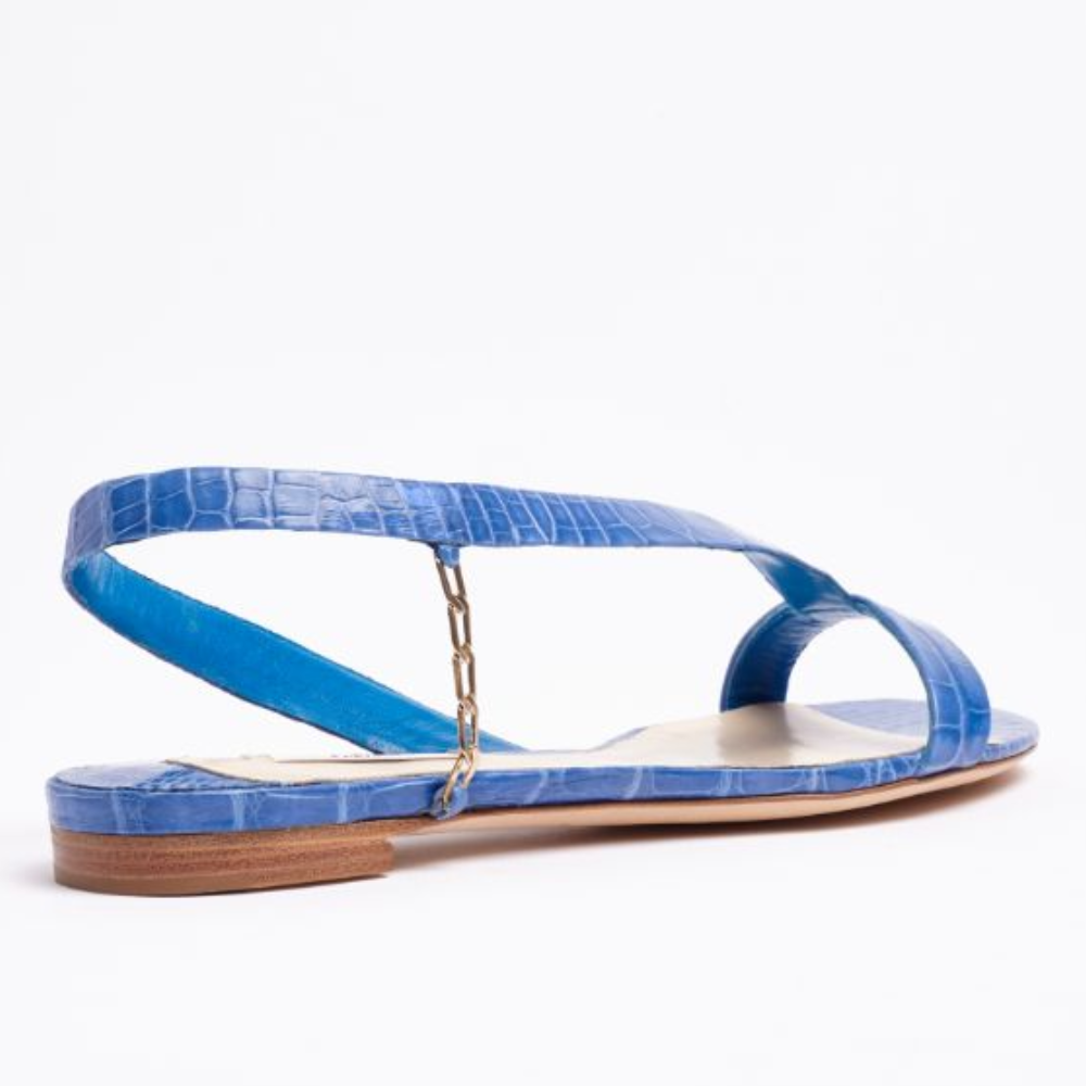 Our L’Amazone flat sandal is designed in blue exotic alligator leather to add instant polish and bold color to any outfit.